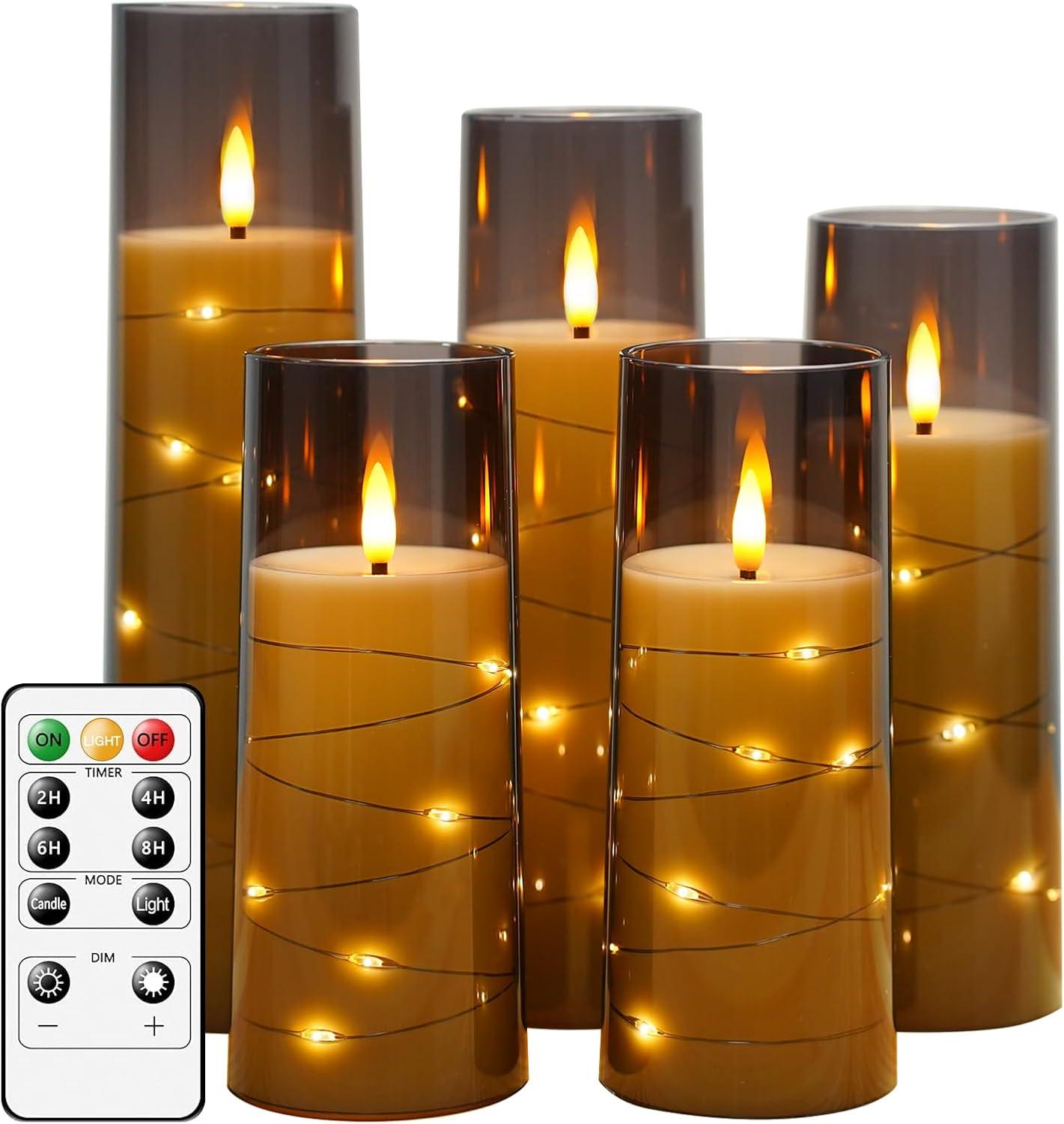 Five smoky grey flameless LED pillar candles with warm flickering flames and tiny star string lights, creating cozy neutral home decor ambiance.