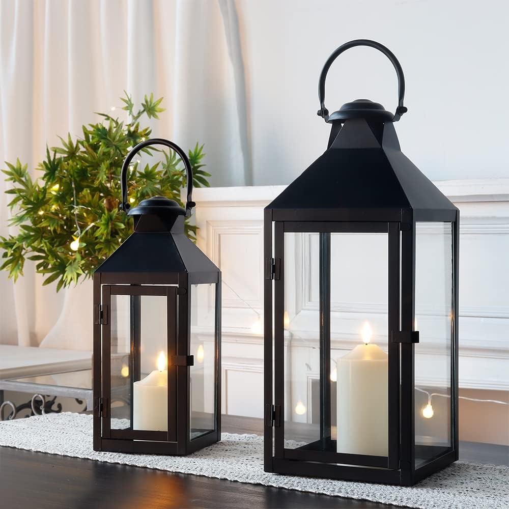 Cozy black metal candle lanterns with warm pillar candles styled beside greenery and string lights